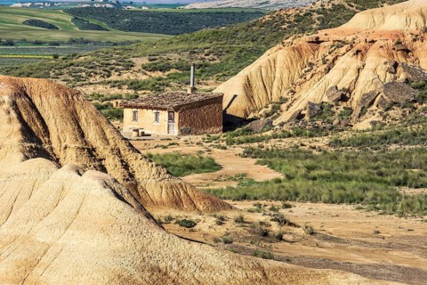 Colorful rock formation, smal hut, semi-desert, Bardena Blanca area, Bardenas Reales Nature Park,