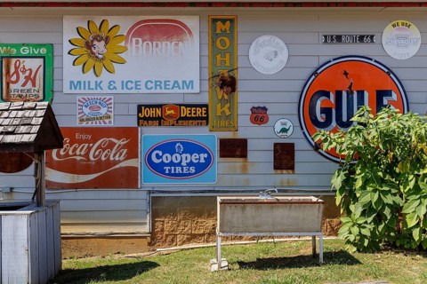 Antique metal advertising signs used for decoration on the side of a building near Counce,