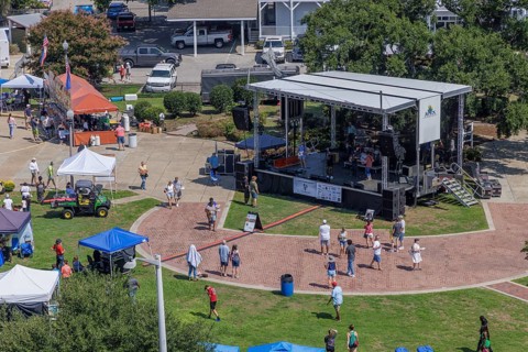 Visitors being entertained with live music at the bandstand during the Biloxi Seafood Festival in