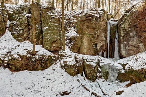 Snow-covered rocks with frozen waterfalls in a forest, The Dragon Gorge near Eisenach in Thuringia