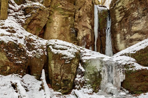 Frozen waterfalls on snow-covered rocks in a winter landscape, The Dragon Gorge near Eisenach in
