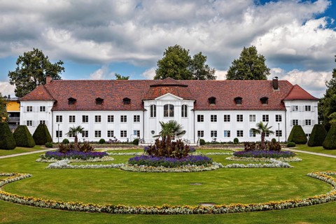 White castle with elaborately designed garden and colourful flower beds, The town of Kempten im