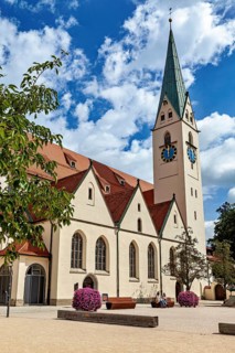 Gothic church with a red roof and well-tended flower pots, The town of Kempten im Allgäu
