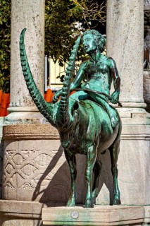 Bronze figure of a rider on a mystical animal, skilfully designed with long horns, The fountain in