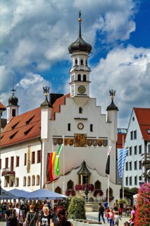 Magnificent baroque town hall surrounded by people and flags, The town of Kempten im Allgäu