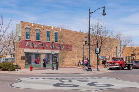 Tourists take photos Standin' on a Corner in Winslow Arizona as sung in the classic Glenn Frey and