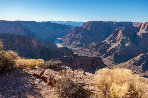 Colorado River runs between rock formations at Guano Point in Grand Canyon West near Peach Springs,