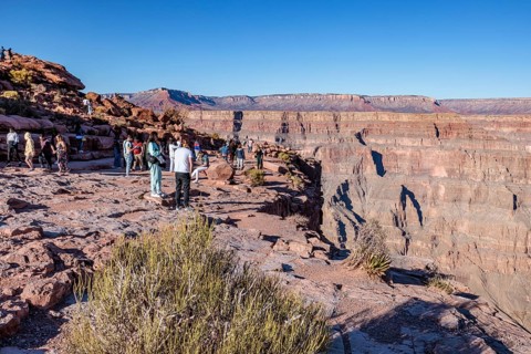 Tourists on the edge of the canyon at Guano Point area of Grand Canyon West near Peach Springs,