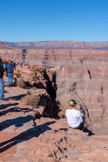 Tourists on the edge of the canyon at Guano Point area of Grand Canyon West near Peach Springs,