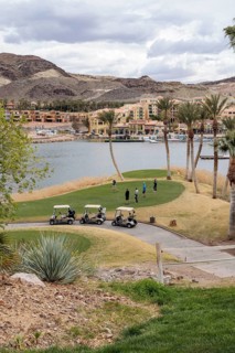 Senior golfers teeing off while playing on a golf course along the shoreline of Las Vegas Wash at