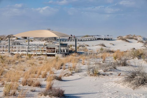 Fabric awning over a portion of the Interdune Boardwalk provides some shade for visitors at White