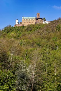 Castle on a high, wooded hill under a clear sky, Wartburg Castle near Eisenach in Thuringia