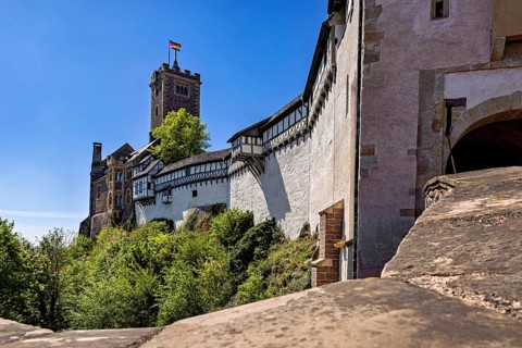 Castle walls with a view of the blue sky and flag, Wartburg Castle near Eisenach in Thuringia