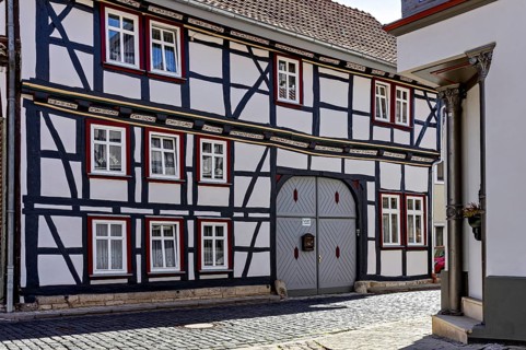 A traditional half-timbered house with a characteristic wooden structure and small windows in a