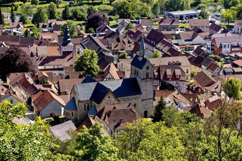 View of a picturesque village with old half-timbered houses and a central church in the