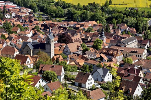 Panorama of a small town with a church, surrounded by fields and green countryside, The town of
