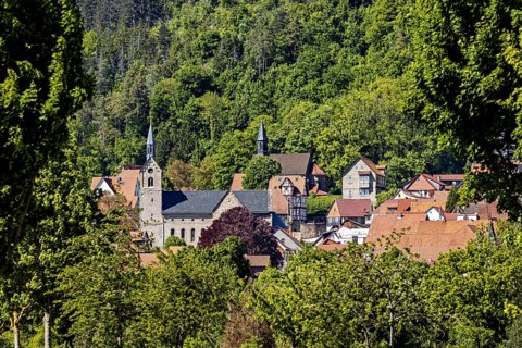 Idyllic village with a church and surrounded by green hills and dense forests, the town of Treffurt