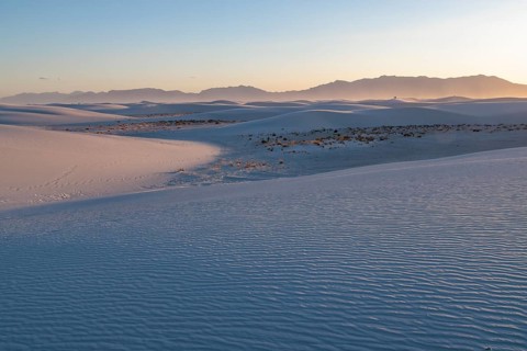 Smooth curved sand dunes in evening light at White Sands National Park in Alamogordo, New Mexico,