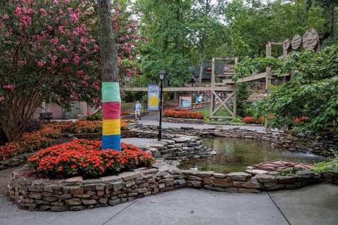 Immaculate landscaping with colorful flowers and water features at the Dollywood amusement park in
