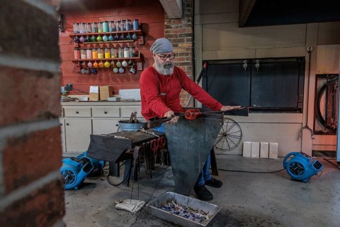 Glass blower demonstrates the art of blowing glass at the Dollywood amusement park in Pigeon Forge,