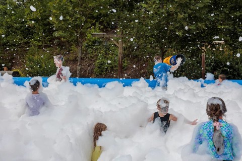 Park guests playing in the bubble foam pit at the Dollywood amusement park in Pigeon Forge, TN