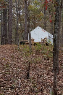 Tentrr glamping tent on a raised platform with a wooden porch at Clarko State Park near Quitman,