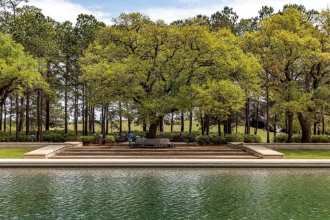 Live Oak trees line the sides of the Mary Gibbs and Jesse H. Jones Reflection Pool at Hermann Park