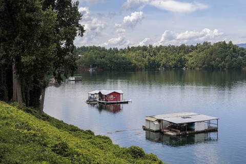 View of a house boats on Fontana Lake as seen from the open air car of the Great Smoky Mountains