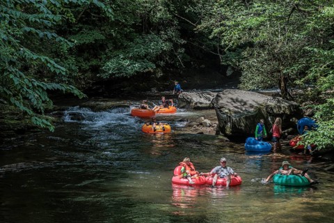 Visitors tubing down Deep Creek in the Smoky Mountains near Bryson City, North Carolina, USA