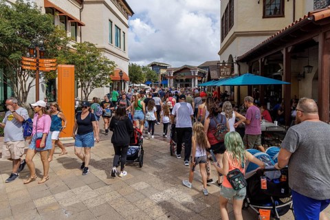 Crowd of visitors walking past The Polite Pig restaurant in Disney Springs at Disney World in