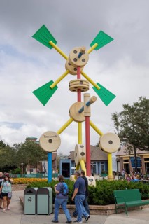 Shoppers and visitors walking past a Tinkertoy sculpture display in Disney Springs at Disney World