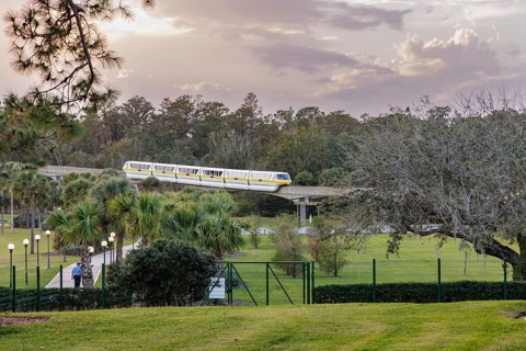 Monorail carries passengers toward the entrance to the Magic Kingdom at Walt Disney World in