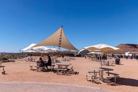 Umbrella shaded tables and a large awning provide visitors shade from the desert sun at Eagle Point