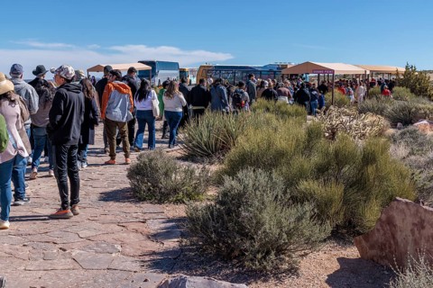 Visitors in line to take bus transportation from Eagle Point area too the Guano Point area of Grand
