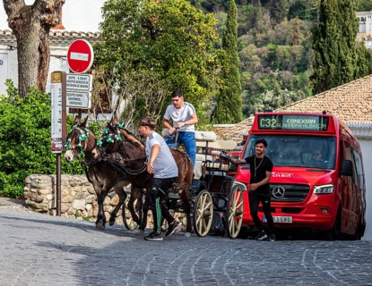 Horse-drawn carriage in the narrow streets of Granada, modern bus behind, Granada, Andalusia, Spain