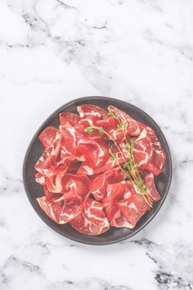 Plate with sliced cured meat, pork neck, prosciutto coppa, Italian delicacy
