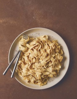 Fettuccine, tagliatelle, in creamy garlic sauce, Italian traditional cuisine, pasta carbonaro