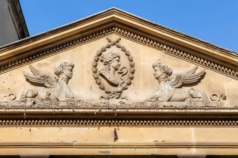 Stonework details pediment above entrance to King's and Queen's Baths, city of Bath, north east
