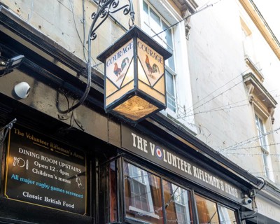 Vintage Courage pub lamp sign outside The Volunteer Rifleman's Arms pub, city of Bath, north east