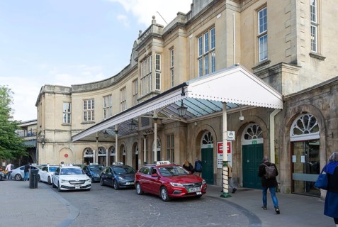 Taxis outside Bath Spa railway station, city of Bath, north east Somerset, England, UK