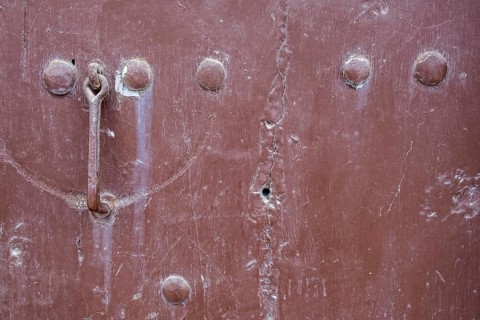 Close-up of a brown metallic surface with rust and bolts, background, texture, Prizren, Kosovo
