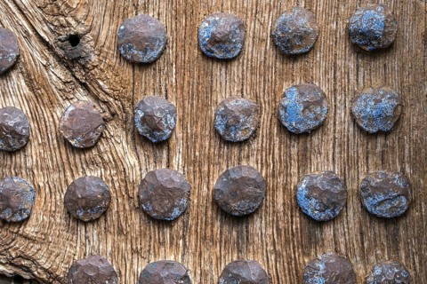 Old wooden door with rusty metal rivets at regular intervals, North Macedonia, Balkans