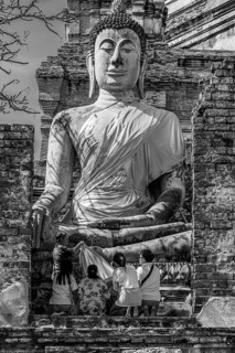 Stone Buddha statue, historic Buddhist temple complex, black and white photo, Ayutthaya, Thailand
