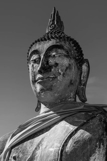 Stone Buddha statue, historic Buddhist temple complex, black and white photo, Ayutthaya, Thailand