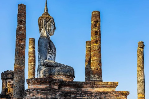 Stone Buddha statue in the historic Wat Mahathat Buddhist temple complex, historical park,