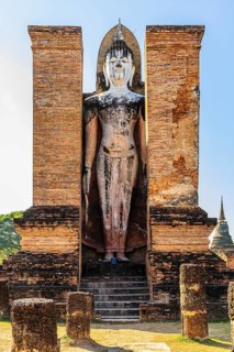 Stone Buddha statue in the historic Wat Mahathat Buddhist temple complex, historical park,