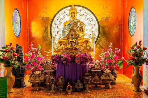 Shrine with gilded Buddhist statue in the main pagoda, Buddhist temple complex Wat Phra That Sorn