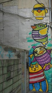 Graffiti with colorful cartoon birds on a wall, Porto, Portugal