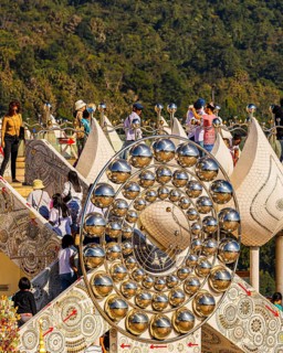 Visitors on the pedestal structure of the five-headed Buddha statue, Wat Phra That Sorn Kaew