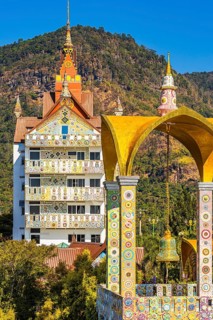 Bell tower decorated with mosaic and glass works of art, Buddhist temple complex Wat Phra That Sorn
